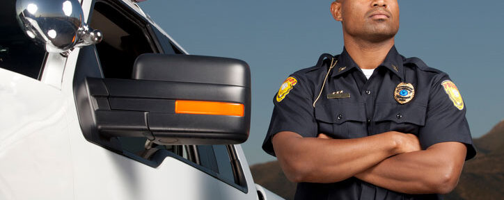 federal law enforcement agent standing next to his car