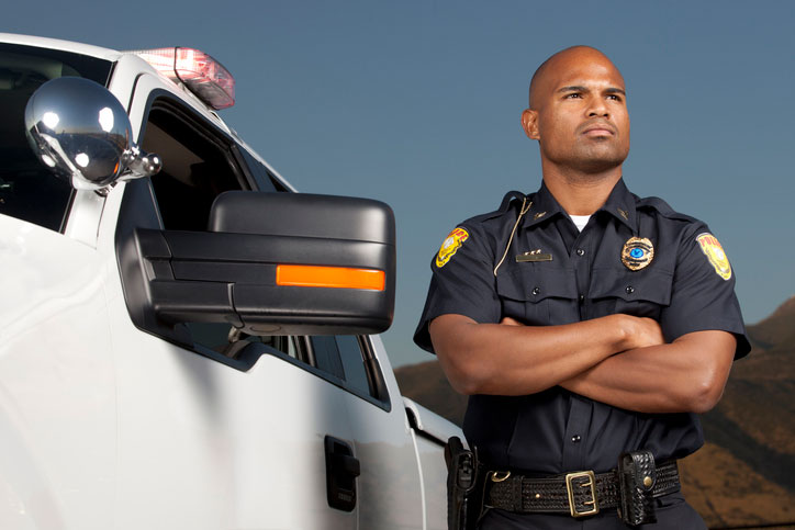 federal law enforcement agent standing next to his car